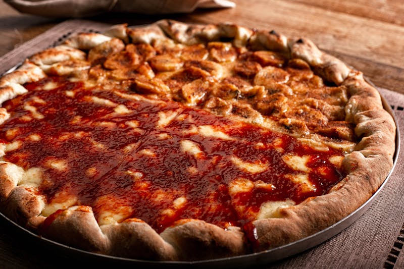 Coal-fired pizza with pepperoni and melted cheese